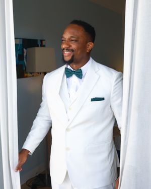 White Three-Piece Suit with Green Bow Tie
